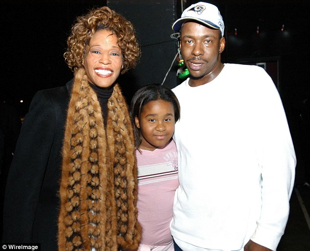 Young Bobbi Kristina is pictured with her parent. Credit: Various