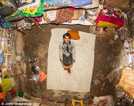 Lalu from Varanasi in India pictured in his bedroom (Photo: John Thackwray)