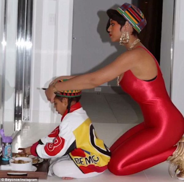 Beyonce touching up Blue's outfit