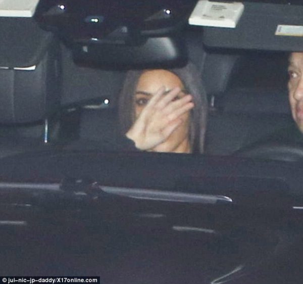 Kim tried to shade her face from the paps