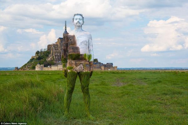 Amazing shot of a man pictured in front of Mont St Michael in Normandy, France