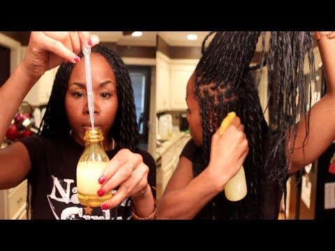 woman applying spray to braids