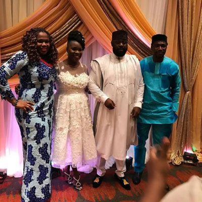 The couples poses with family members