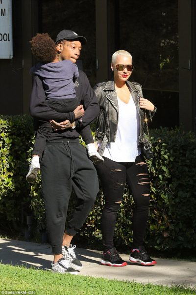 Wiz carries their son while spending time with Amber