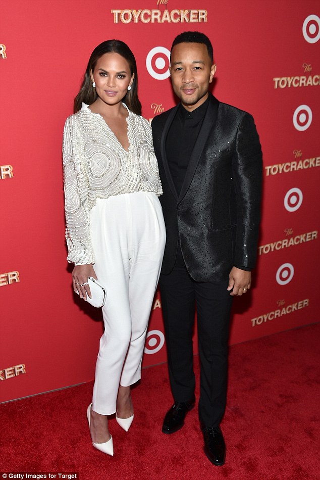Meanwhile we can't get enough of this couple's outfit - From Chrissy's plunging beaded top to the high-waist trousers, she looked simply divine in her all-white outfit.