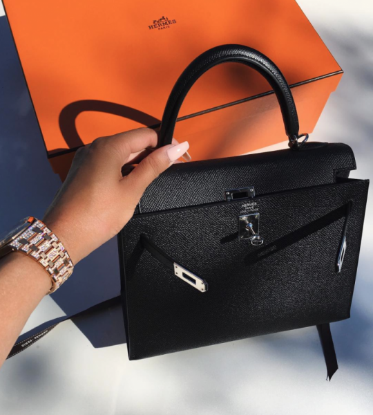 Jyoti showing off a Hermes bag she got as a present
