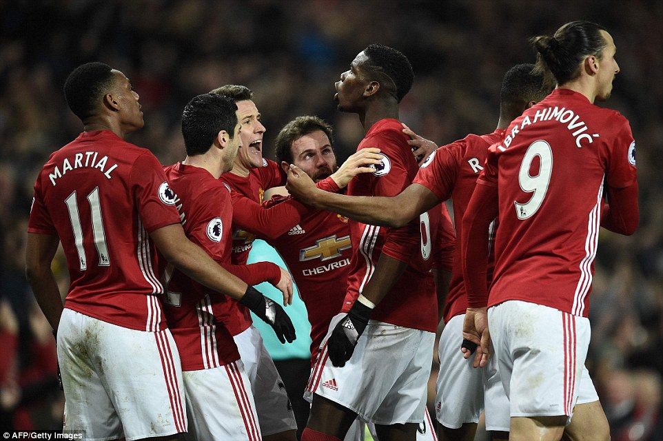 Paul Pogba celebrates late header with teammates.