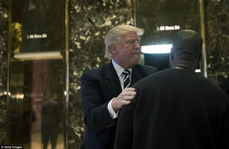 President-elect Donald Trump and Kanye West pose for a picture in the lobby of Trump Tower in New York, Tuesday, Dec. 13, 2016. (AP Photo/Seth Wenig)