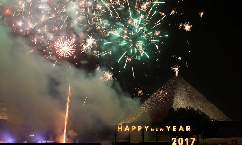 Fireworks explode above the pyramids during New Year’s day celebrations on the outskirts of Cairo, Egypt. Photograph: Mohamed Abd El Ghany/Reuters