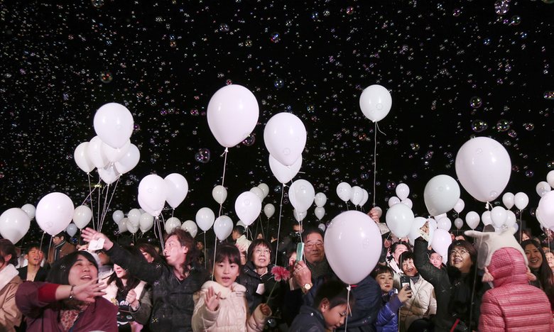 Balloons float over visitors during a New Year’s Eve celebration at a Tokyo hotel. Photograph: Koji Sasahara/AP
