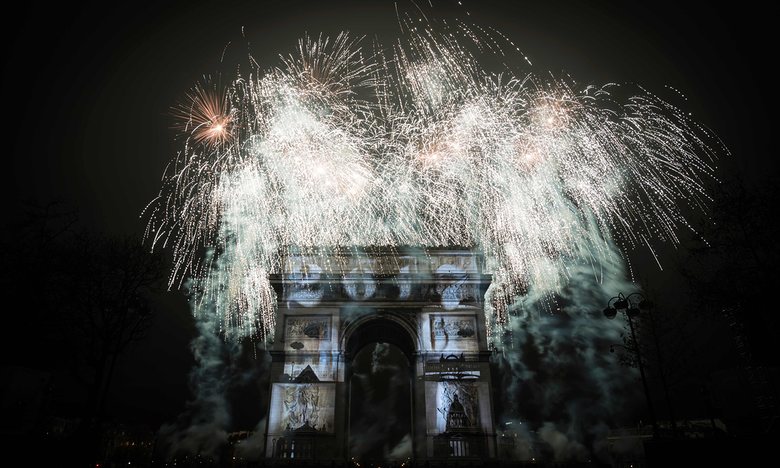 Fireworks explode over the Arc de Triomphe as part of New Year celebrations in Paris. Photograph: Lionel Bonaventure/AFP/Getty Images