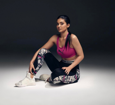 Kylie Jenner poses in pink sports bra and patterned leggings for Puma