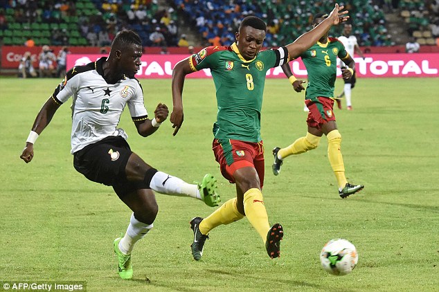 Cameroon’s Moukandjo blocks pass by Acquah