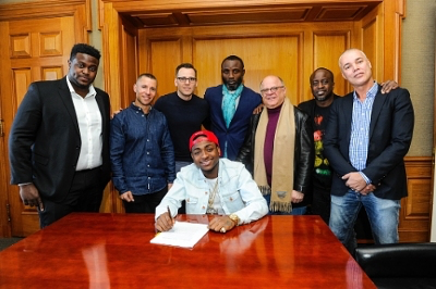 Davido was all-smiles when he signed a recording deal with Sony Music last year. Credit: Various