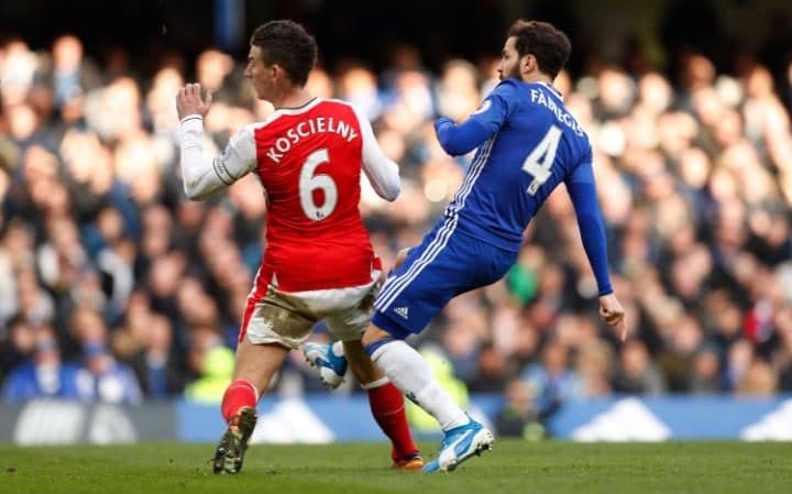 Koscielny competes for the ball with Fabregas.